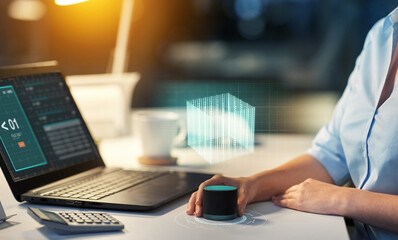 technology, automation and people concept - close up of hand using smart speaker on table with...