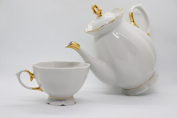 White porcelain teapot with cup