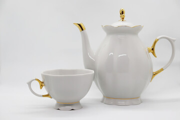 White porcelain teapot with cup