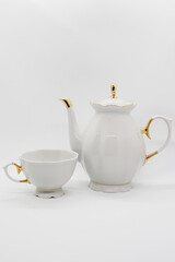 White porcelain teapot with cup