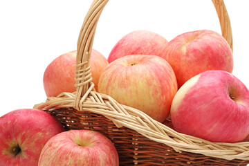 apples in basket on white.