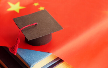 Graduation cap on Chinese flag. Language learning. China student concept 