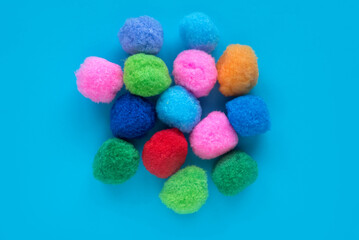 Fototapeta na wymiar Colorful cotton balls on blue background.