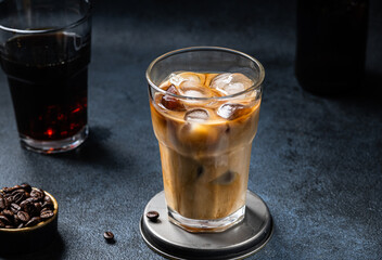 Ice coffee in a tall glass with cream poured over. almond milk latte. Cold summer drink. Cold brew in glass. vegetarian coffee in glass. Vietnamese Iced Coffee. vegan latte