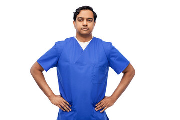 healthcare, profession and medicine concept - indian doctor or male nurse in blue uniform over...