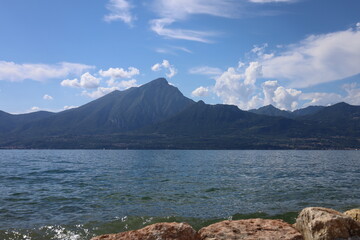 Torri del Benaco, Italy, Lake Garda, August 2021 View of the lake and the mountain formation from the east side to the west side of the lake in beautiful weather with blue sky