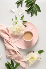 Obraz na płótnie Canvas Morning romantic coffee cup, white peonies flowers on light gray background. Feminine workplace, top view, flat lay. Concept mental health for women. Tranquility and relaxation.