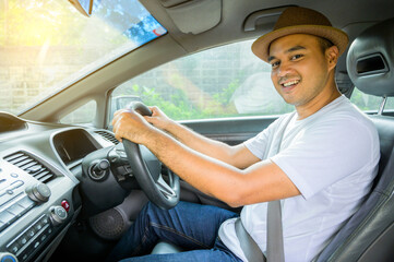 Young asian man smiling in his car.Travel concept, Safety first insurance concept