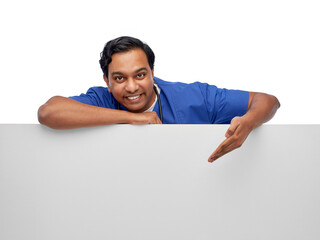 healthcare, profession and medicine concept - happy smiling indian male doctor or nurse in blue uniform with big board over white background