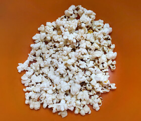 Popcorn food in red bucket. White pop corn delicious snack on yellow background.