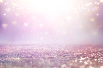 purple and pink glitter vintage lights background. defocused. hearts overlay