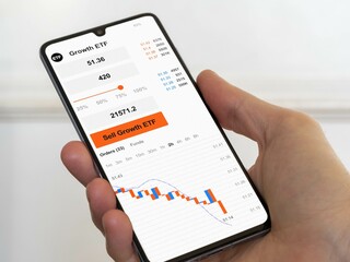 Stock exchange etf market chart down, bear market data on smartphone. Exchange-traded fund....