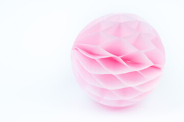 pink honeycomb pom-pom paper ball decoration isolated over the white background.