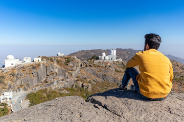 Hiker young boy over looking Aravalli Range with guru shikhar  Mount Abu, Rajasthan.