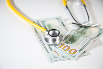 A stethoscope and money - Healthcare cost concept