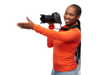 people, profession and photography concept - happy young woman with digital camera over white...