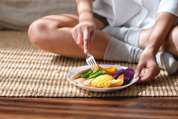Closeup image of a woman eating vegetables, Vegan, clean food, dieting concept