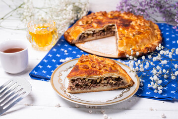 a piece of cut meat pie on a white background