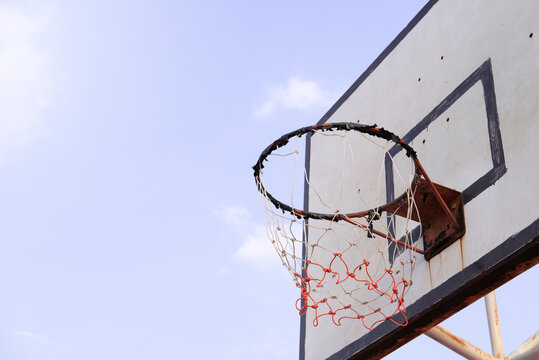 Photo of basketball hoop and basketball backboard at outdoor court see the bright sky It is a team sport. A sport about jumping, precision and speed
