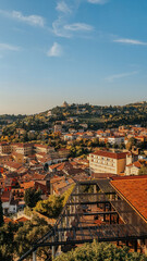 Photo taken from the top of the castle in Verona.  View of mountain houses with blue sky.