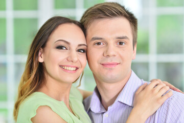 Portrait of happy young couple posing at home