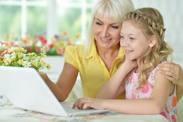 mother and daughter looking at laptop computer