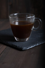 Cafe espresso layered coffee in a see through glass coffee cup.
