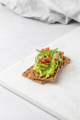Healthy avocado sandwich with avocado paste and tomatoes. Guacamole.