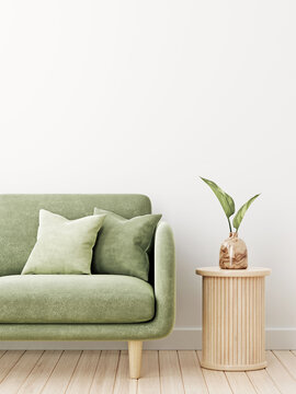 Wall mockup in living room interior with green velvet couch, pillows and leaves in wooden vase standing on slat side table. Illustration, 3d rendering