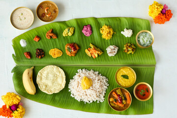 Traditional Onam sadhya rice Sambar, Rasam, parippu dal curry ghee Pappadom Payasam on banana leaf...
