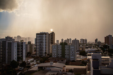 londrina city window view showing downtown buildings with a summer rain cloud cobrandino a part of...