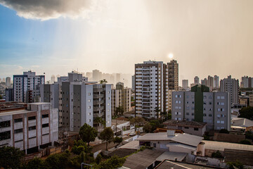 londrina city window view showing downtown buildings with a summer rain cloud cobrandino a part of...