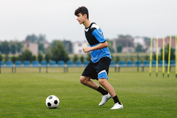 Young Footballer Running Ball During Soccer Training Unit. Football Education for Youths