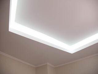 Parts of a designer stretch ceiling with diode lighting. Modern ceiling renovation, interior