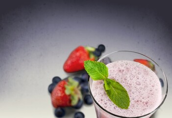 Tasty milkshake with blueberries in a glass on  background. Healthy dessert