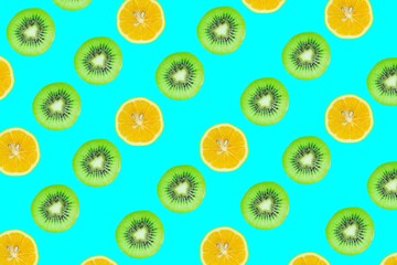 Fruits seamless pattern. Kiwi and lemon slices isolated on blue background.