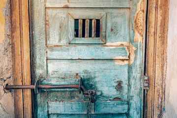 Scary and rusty grunge door to the detention cell in old prison. The concept of fear of conviction and penitentiary system.
