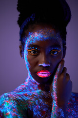 Beautiful extraterrestrial model woman in neon light. It is portrait of beautiful black model with...