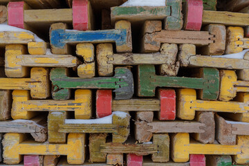 Equipment for concrete work at a construction site. Wooden piled formwork beams.