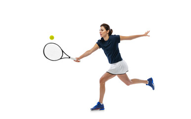 Portrait of young sportive woman, tennis player playing tennis isolated on white background....