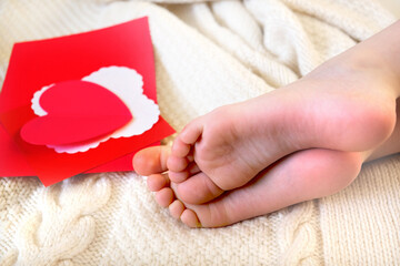 Blurred bare feet, card heart and  happy time for relax. Lazy holiday  and Valentine`s day