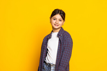 funny child girl wearing glasses on a yellow background