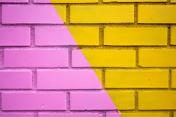 A Two Toned Brick Wall In Pink And Yellow.