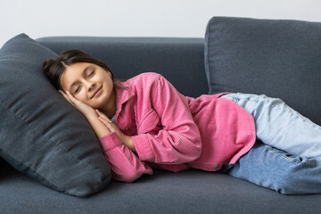 Fototapeta premium Beautiful teenage school girl sleeping on sofa