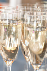 catering. beautiful glasses of champagne with bubbles on the table in the sun. serving. party. wedding