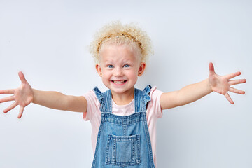 charming expressive emotional blonde girl stretching arms for hug, looking at camera. Blue eyed child girl with curly hair is kind and pleasant. Natural beauty, children human emotions concept