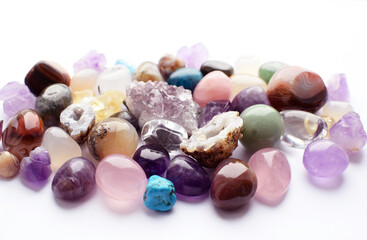 Gems of different colors. Amethyst, rose quartz  lie on a white background.