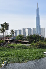 Obraz premium Riverside Shanties and Modern High Rise Apartments on the Saigon River