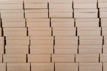 Wall made of closed cardboard boxes stacked in pattern
