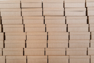 Fototapeta premium Wall made of closed cardboard boxes stacked in pattern